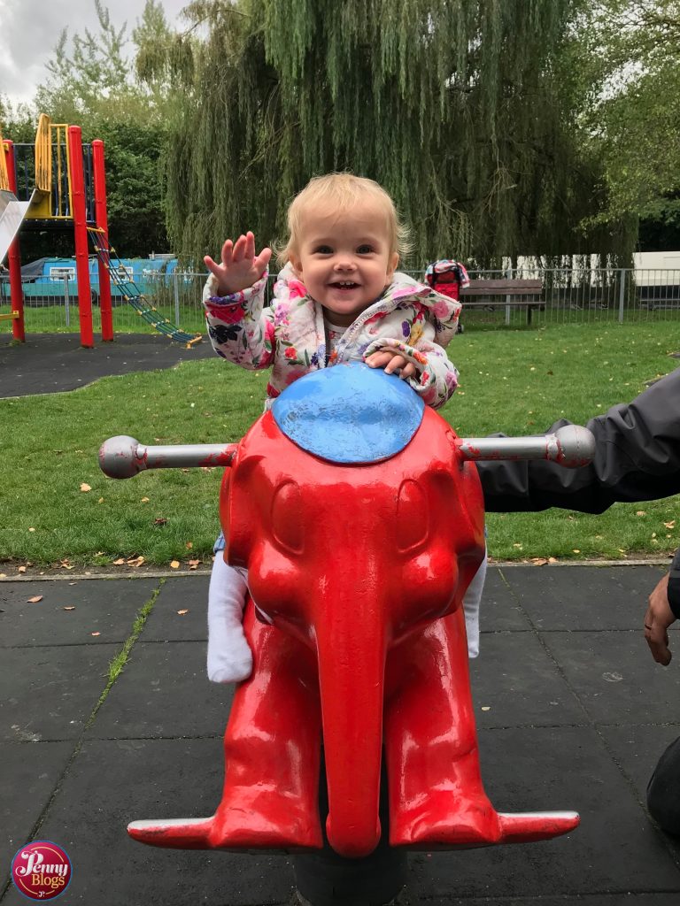 September - Tube Stop Baby riding on a elephant in a playground