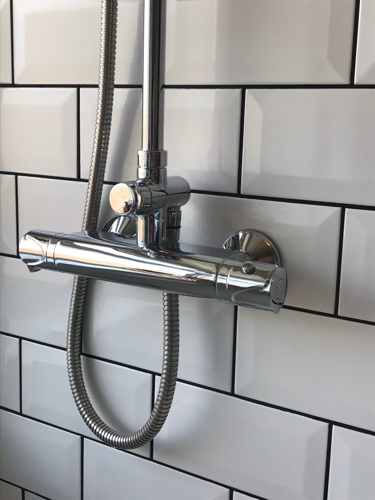 A close up of the new shower and the white metro tiles with black grout in the background. A million miles away from the previous bathroom pictures.