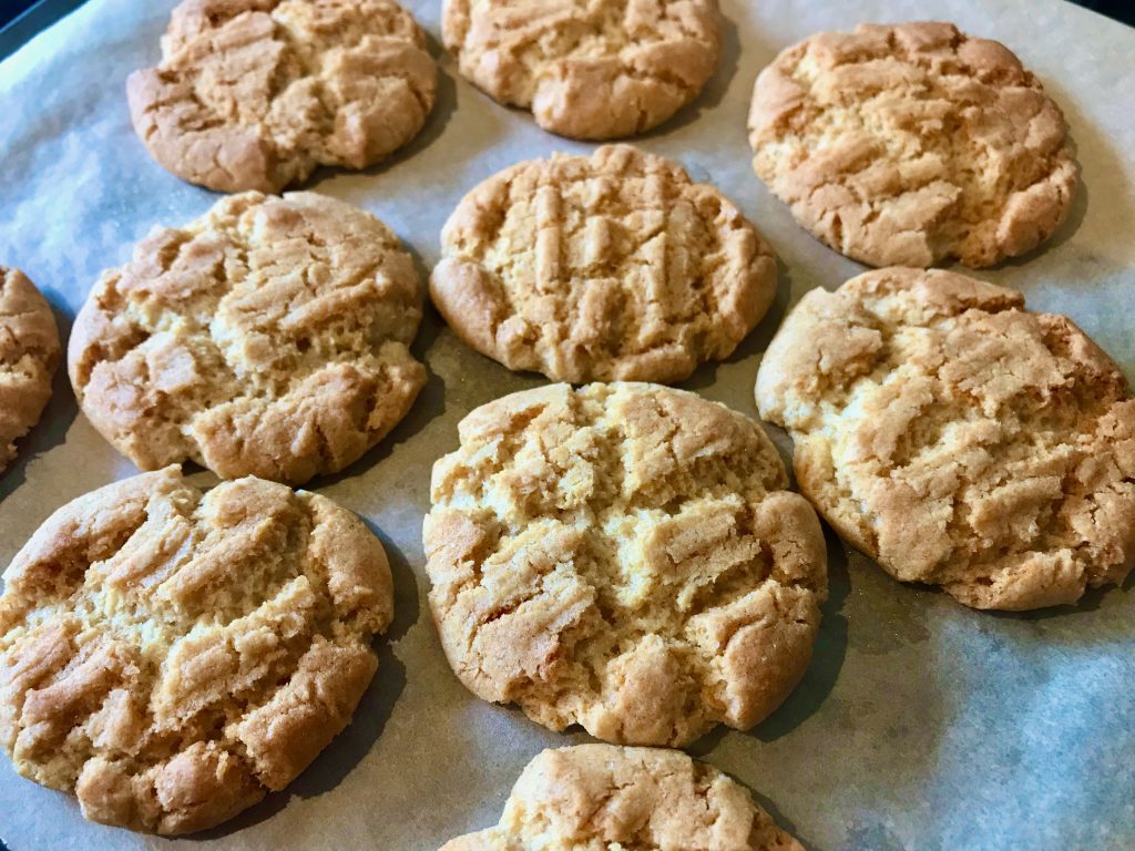 A selection of home baked Gran's ginger biscuits fresh out off the oven laying on a piece of greaseproof paper