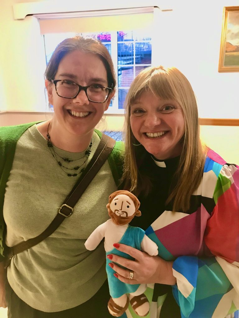Penny stood with the Rev Kate Bottley as she holds a chicly toy version of Jesus.